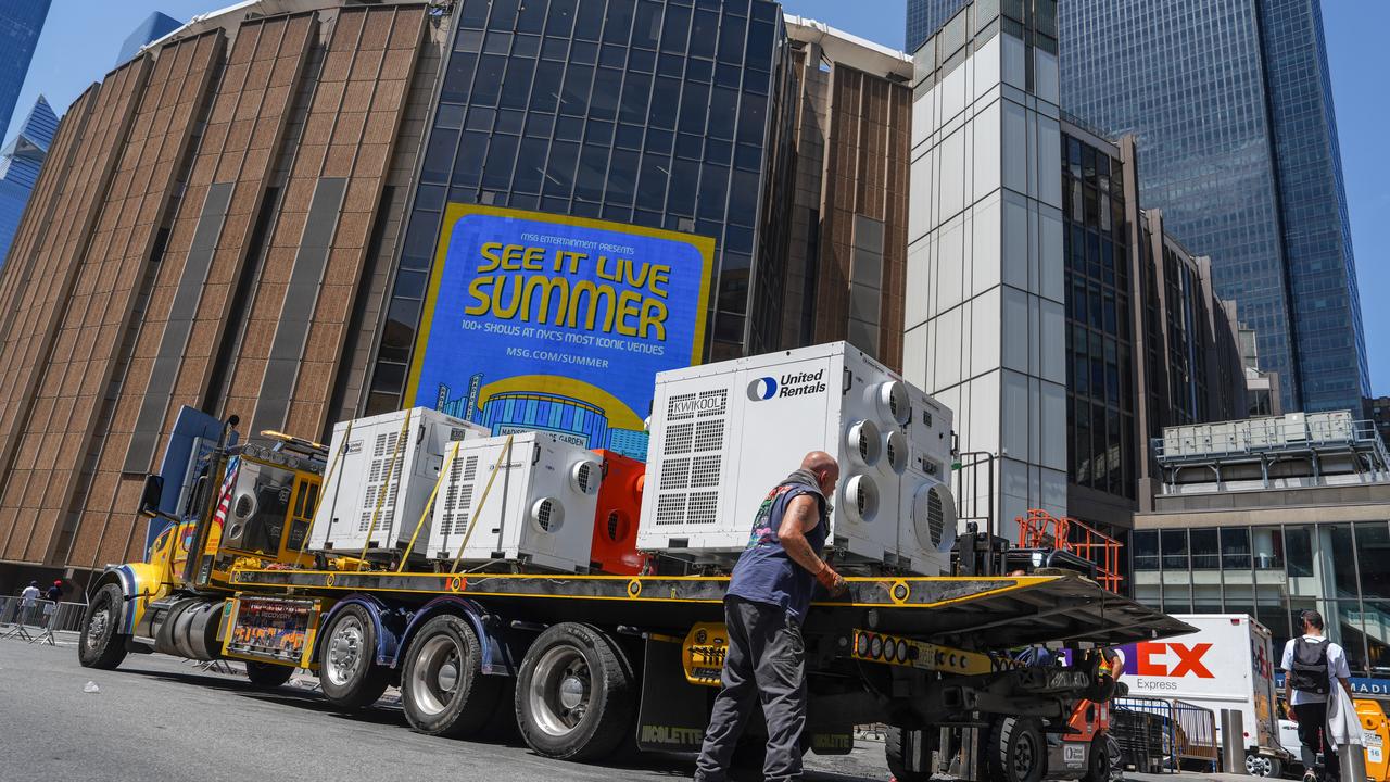 A worker unloads air-conditioning units at Madison Square Garden