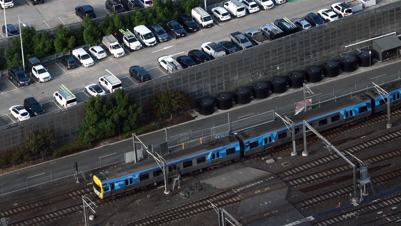 A train passes cars parked at a station (file image)
