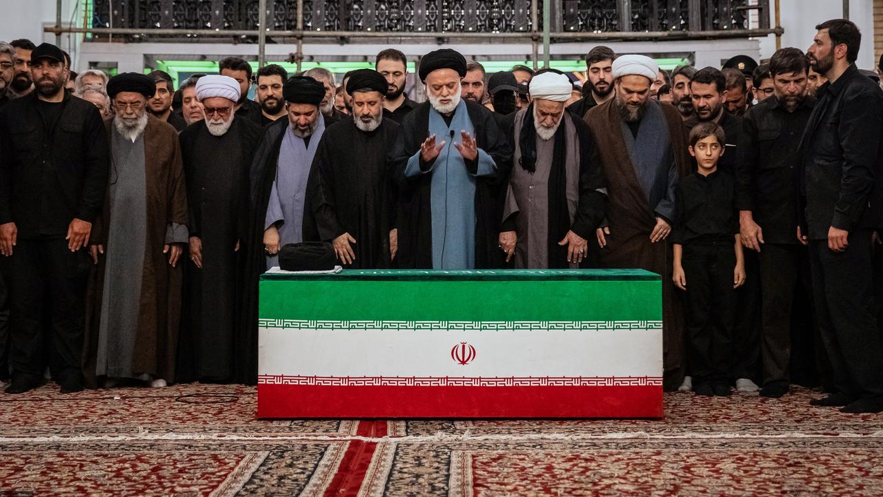 The coffin of Iran's late Supreme Leader Ali Khamenei with relatives