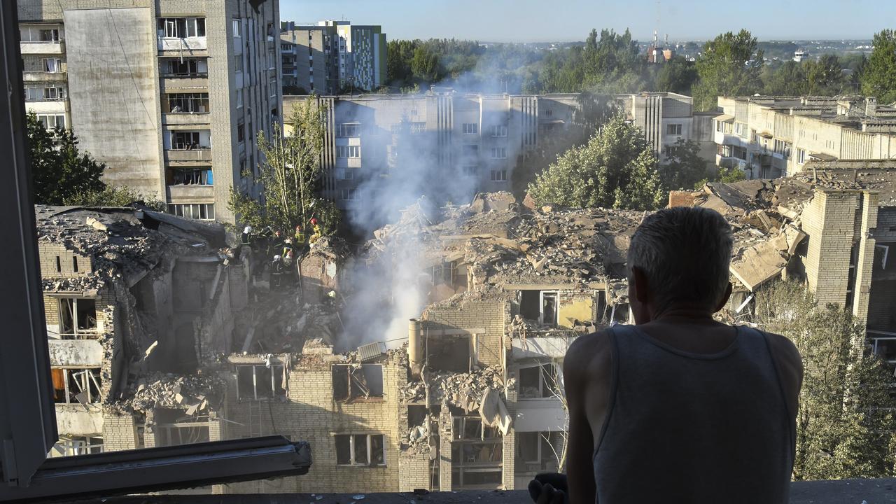 A man looks at the site of a Russian missile strike in Lviv