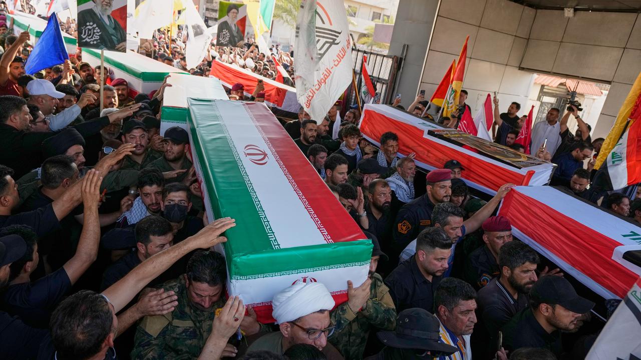 Mourners carry coffins draped in the Iranian flag in Mosul, Iraq