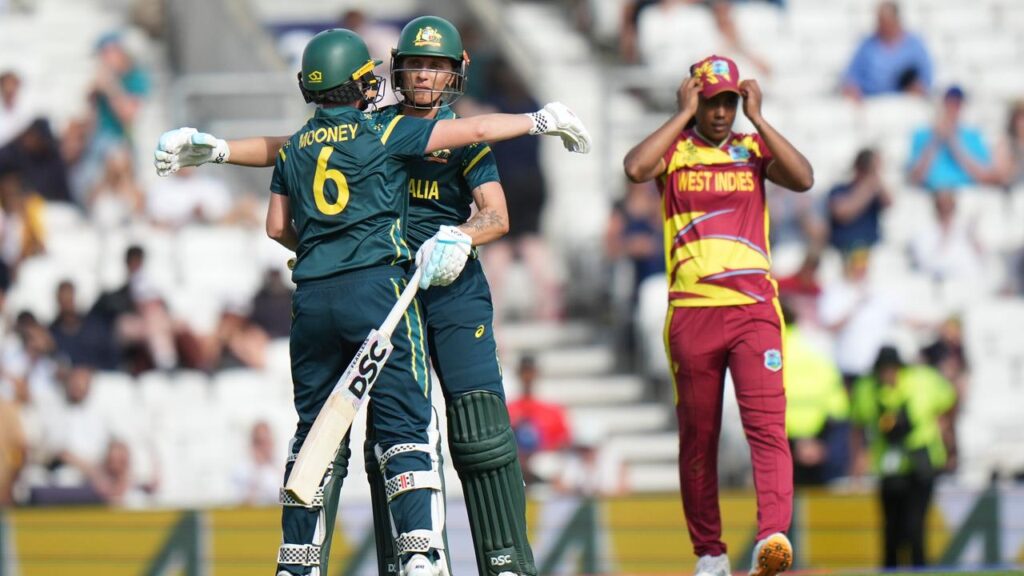 Australia stars Beth Mooney and Ash Gardner celebrate after winning their T20 World Cup semi-final.
