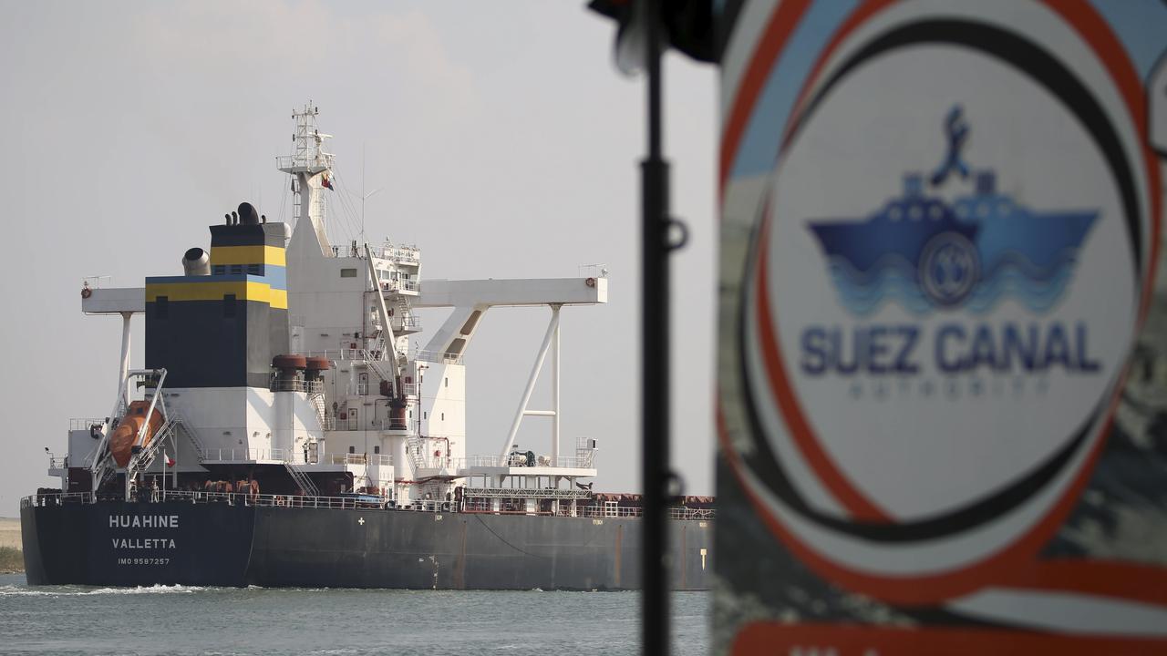 A cargo ship sails through the town of Ismailia, Egypt