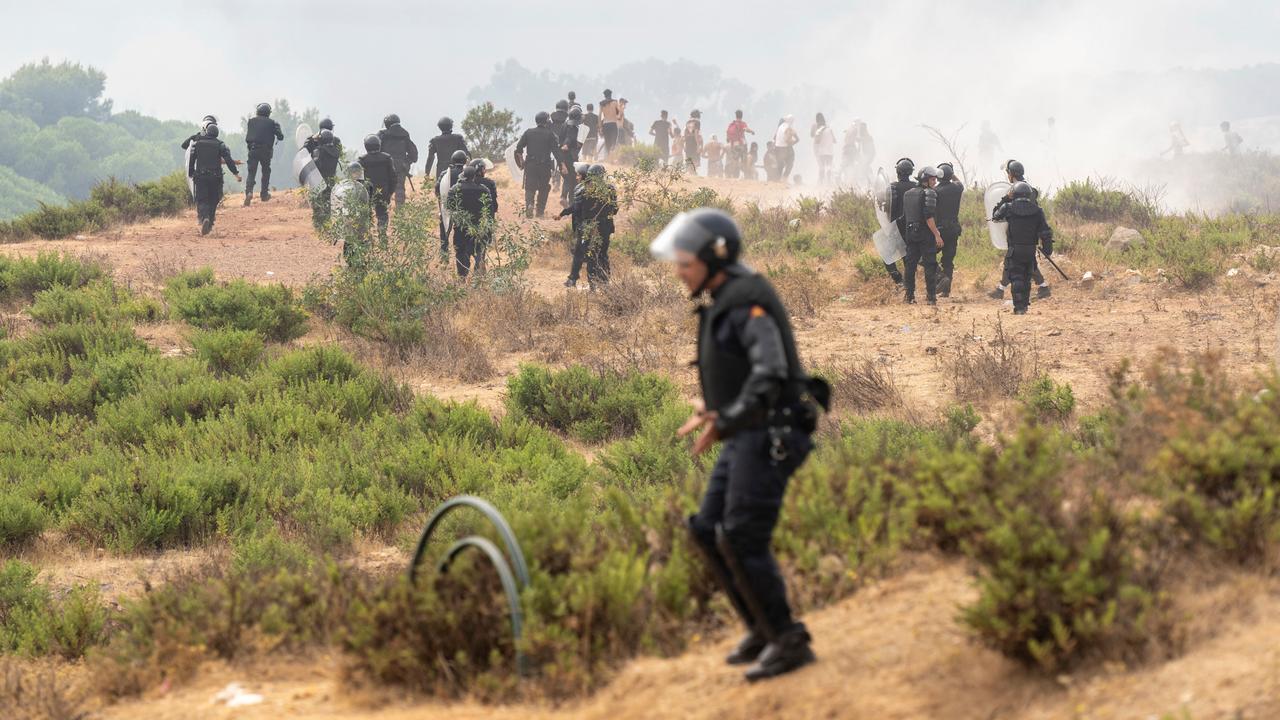 Members of Moroccan security forces disperse people