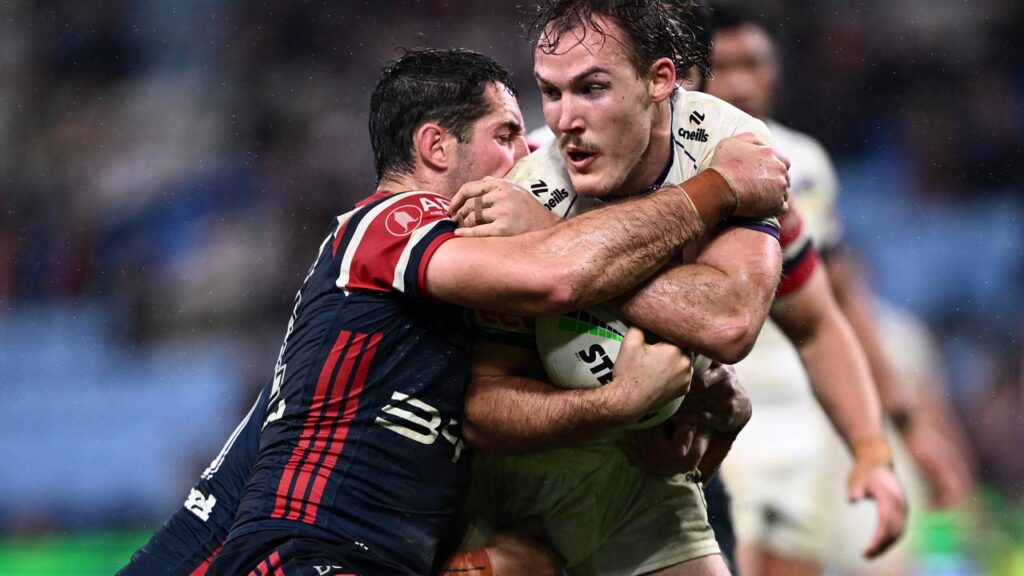 Roosters’ Nat Butcher (l) was penalised for a late hit on Storm’s Alec MacDonald at Allianz Stadium.

