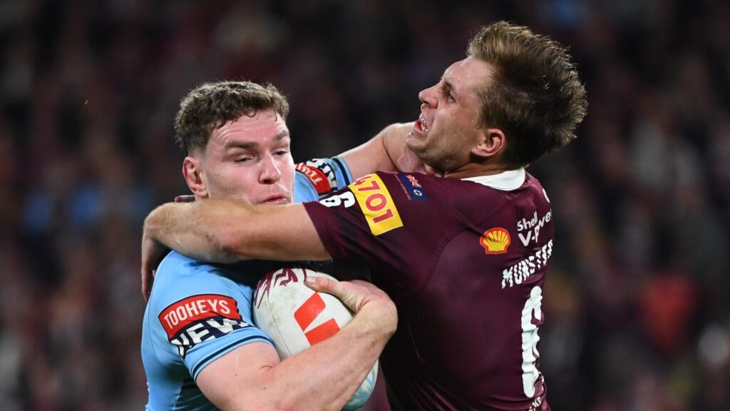Queensland captain Cameron Munster (right) is ready to take on NSW enforcer Liam Martin.
