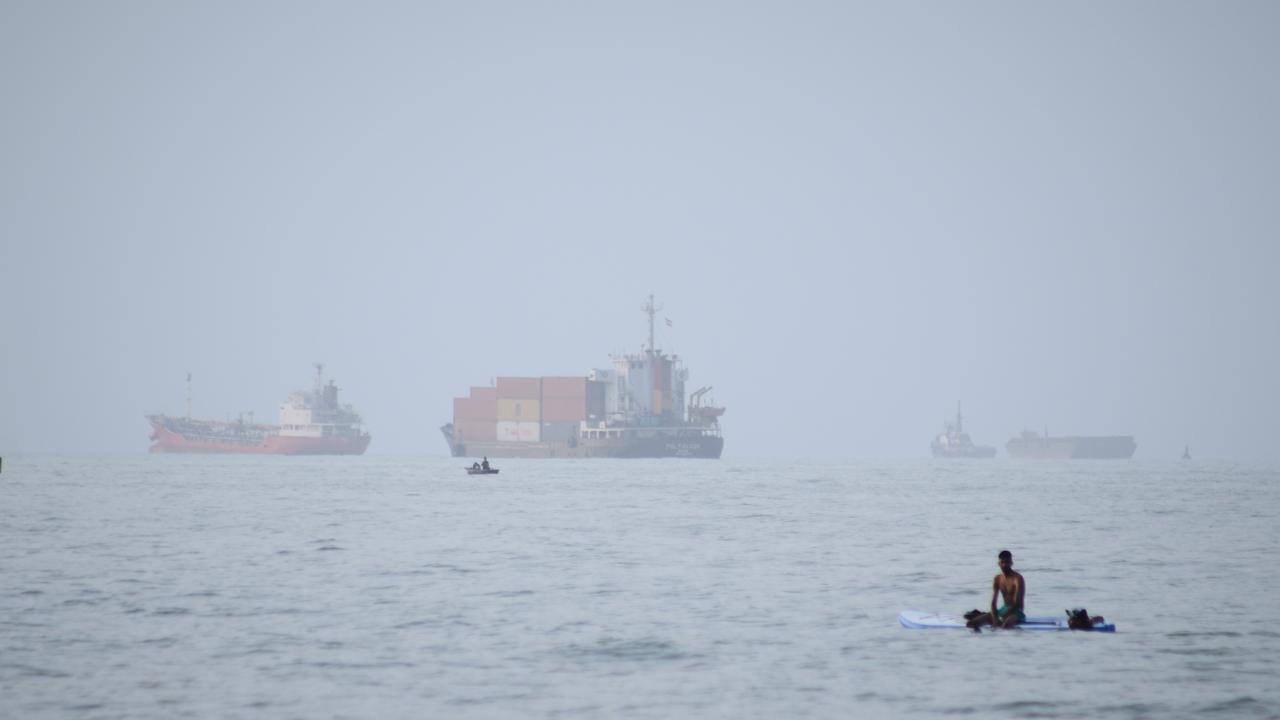 Commercial vessels appear anchored in the Strait of Hormuz