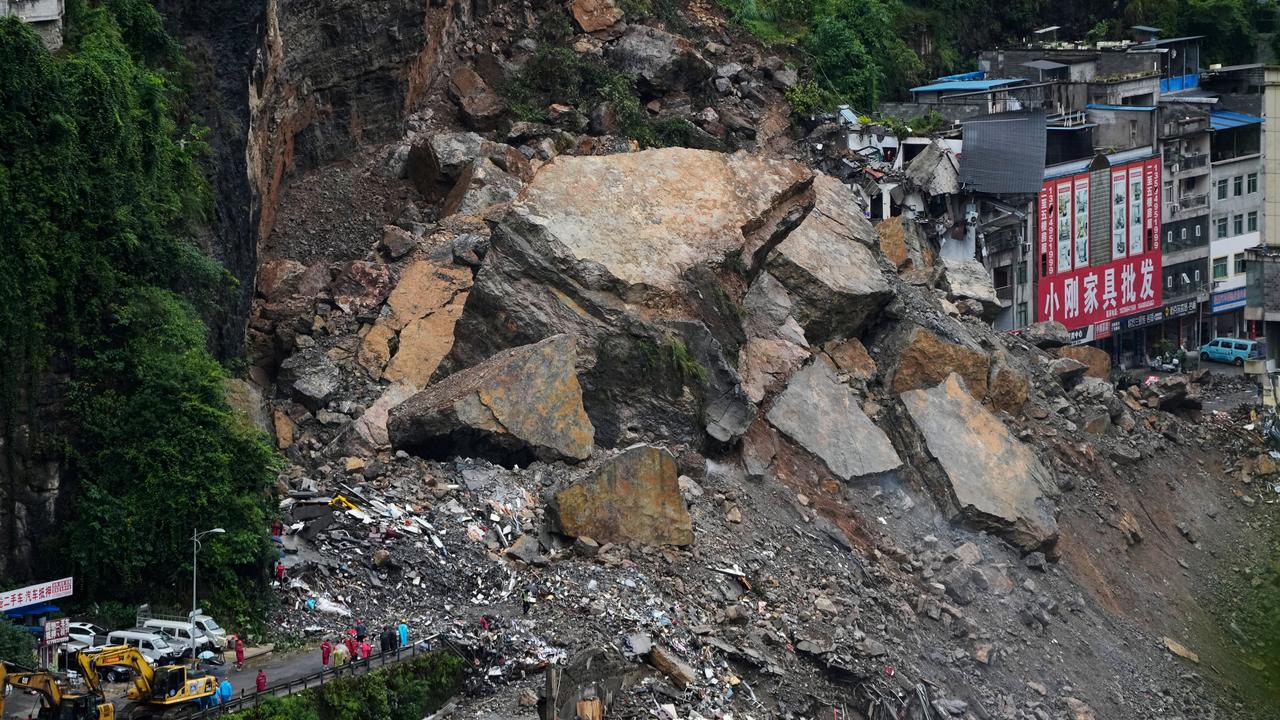Rescuers stand by to search after a landslide in China's Chongqing