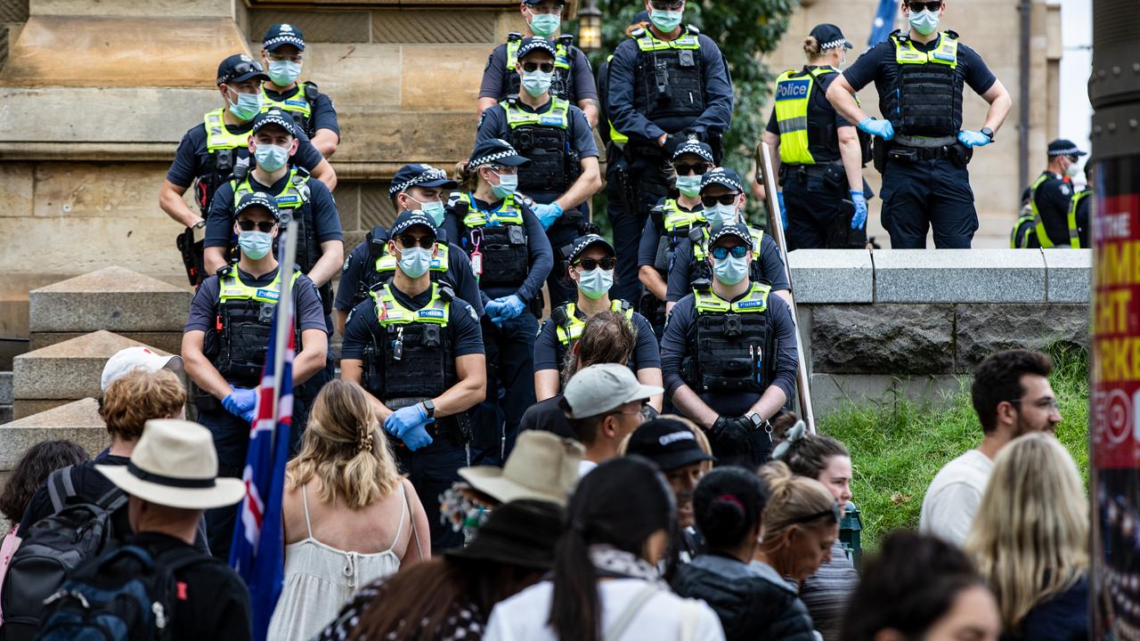 Victoria Police stand in front of anti-vaccination protesters
