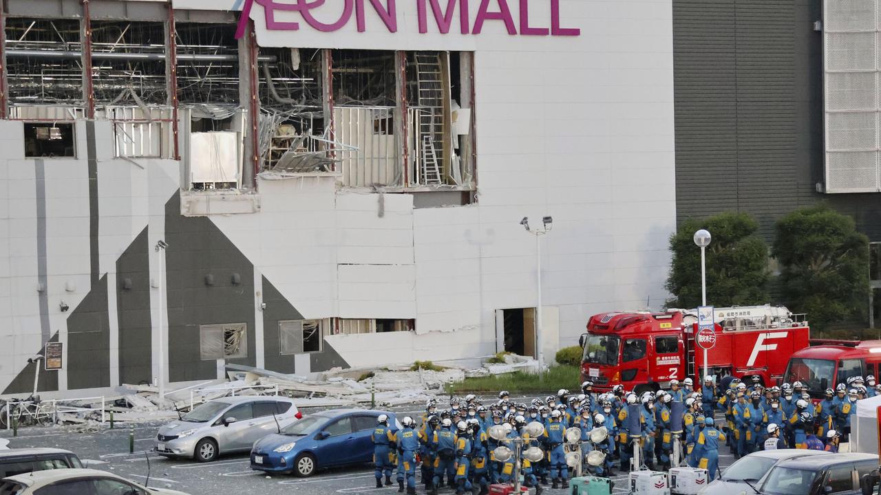 Police units gather in the car park at Aeon Mall Kumamoto prefecture