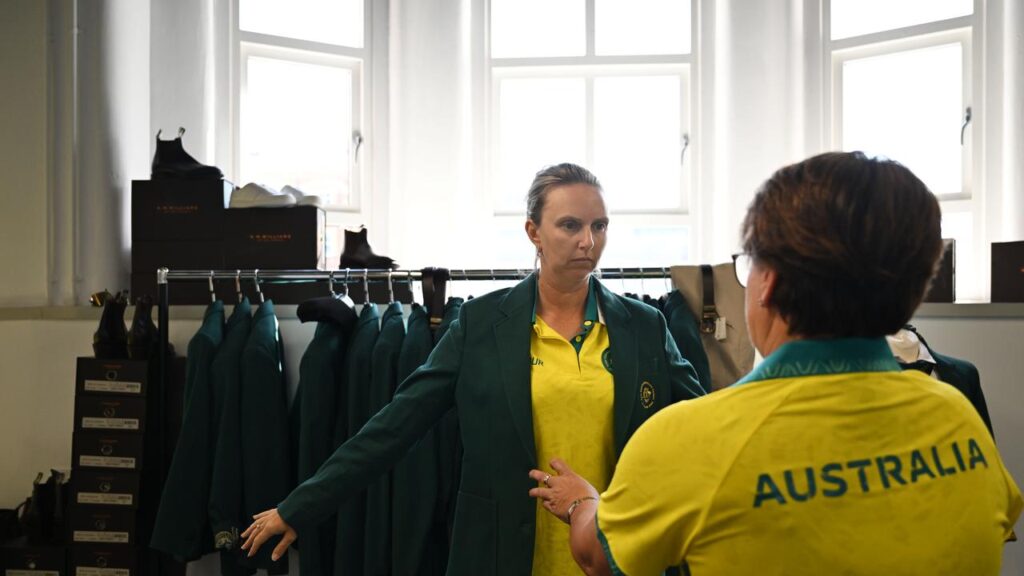 Three-time medallist Kelsey Cottrell is fitted for her Australian team uniform in Glasgow.

