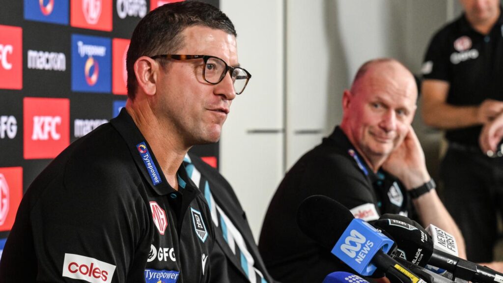 Josh Carr is not worried about the looming player raid by new Tasmania coach Ken Hinkley (right).
