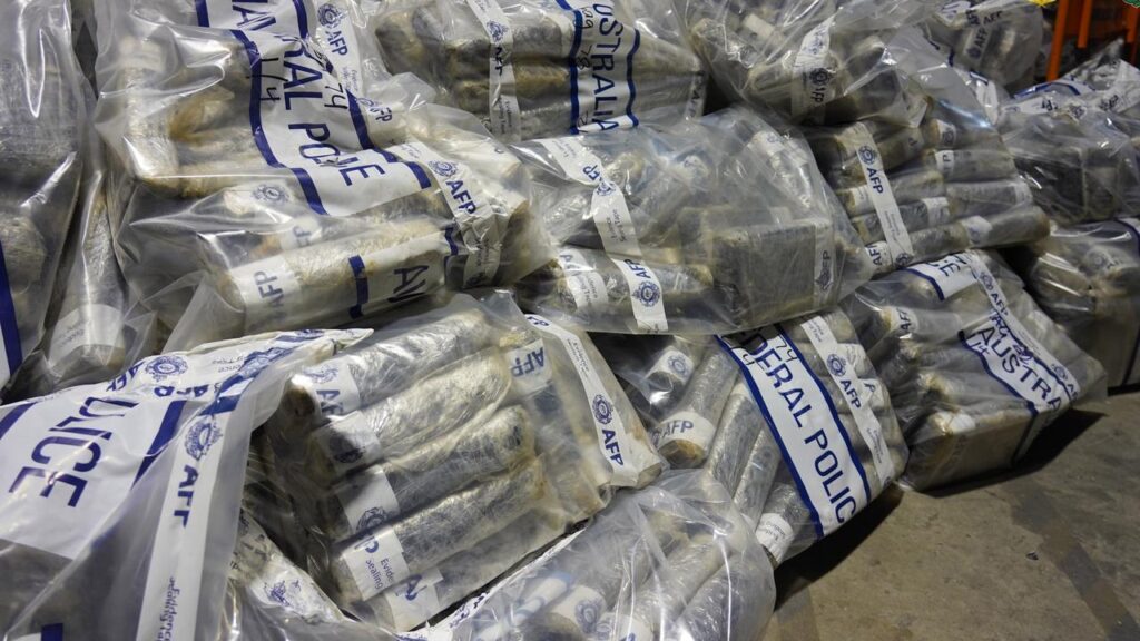Investigators allege the cocaine was hidden in plastic tubs buried under shipping containers.
