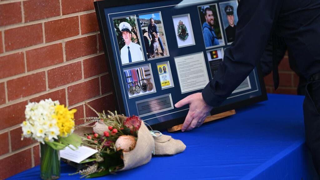 Family and colleagues are still struggling with the loss of two officers gunned down on the job.
