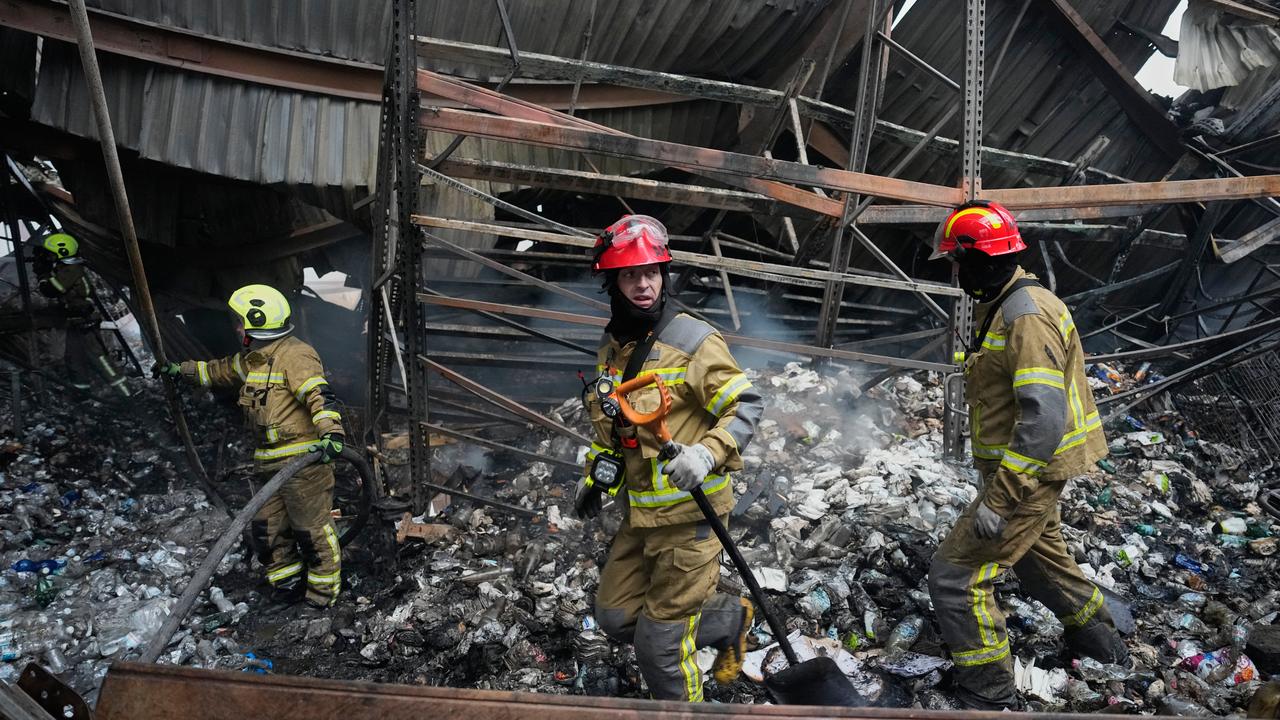 Firefighters after Russian missiles hit a food warehouse near Kyiv