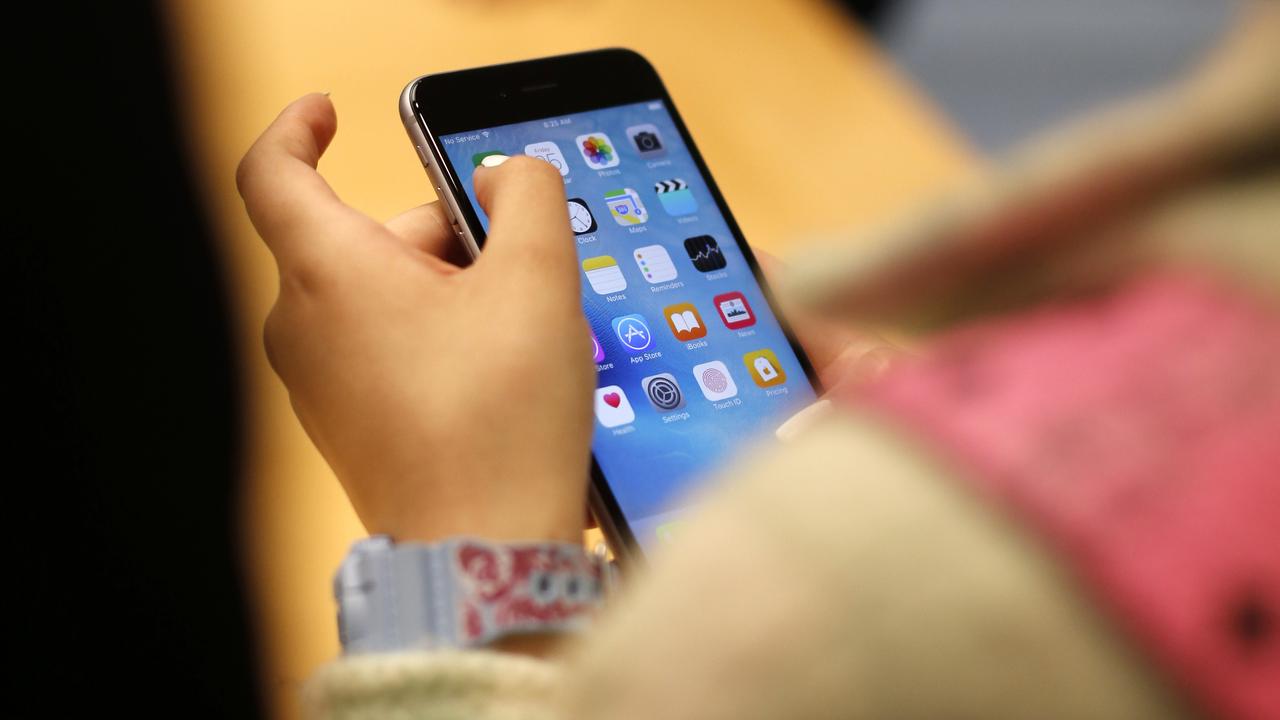 A child holds an iPhone