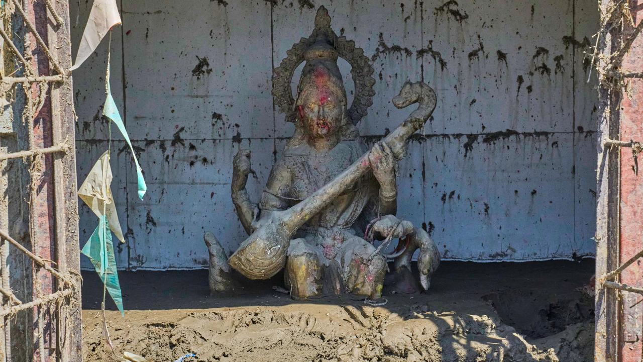 statue of the Hindu Goddess of learning Saraswati, covered in mud