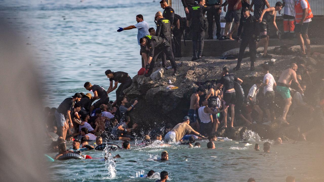Migrants try to cross from Morocco into the Spanish enclave of Ceuta