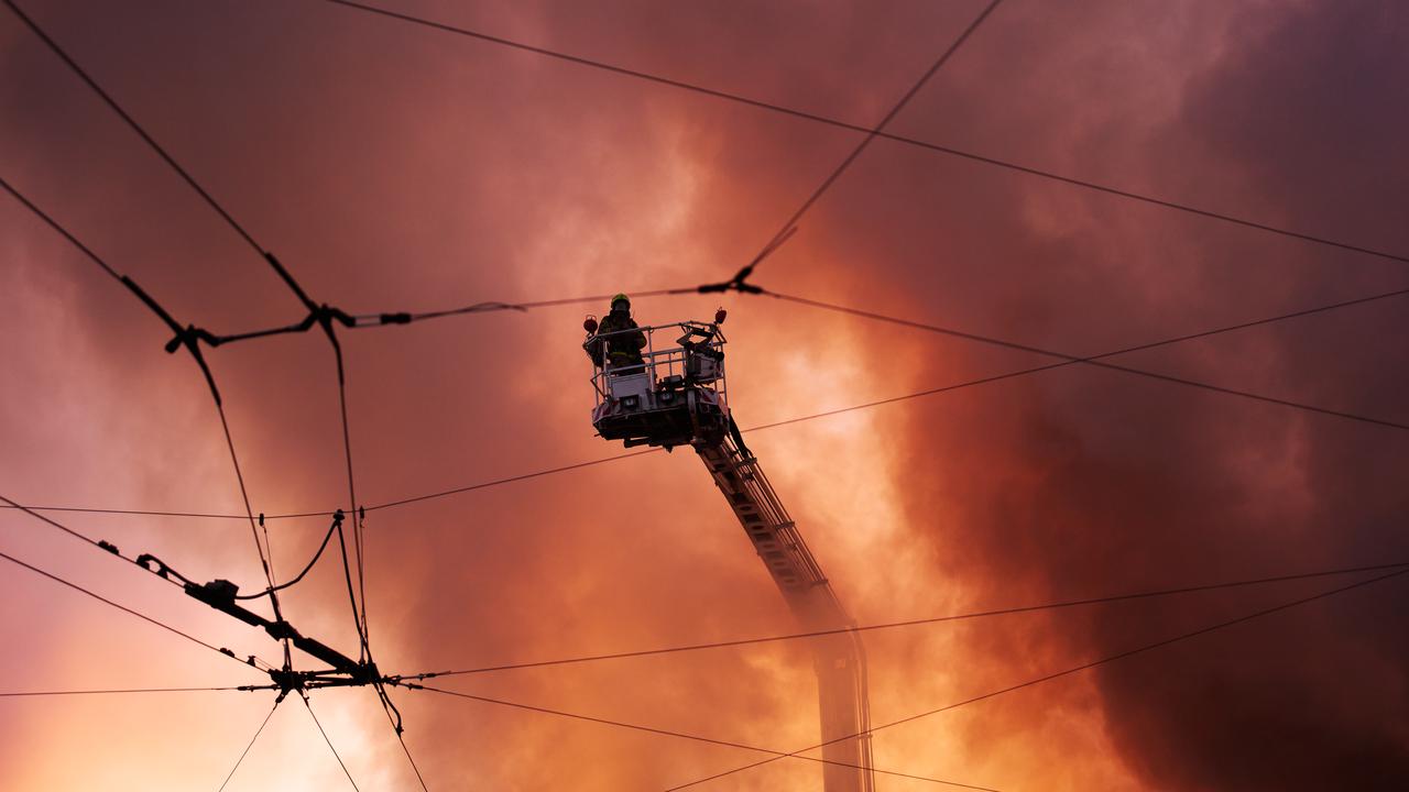 Firefighters putting out a blaze from a Russian missile attack in Kyiv