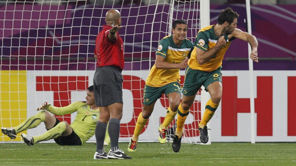 Sasa Ognenovski (r) celebrates after scoring for the Socceroos in their 2011 Asian Cup semi-final.
