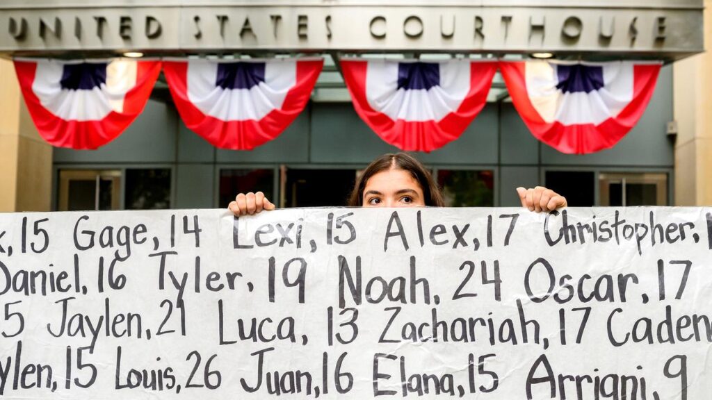 Protesters have held a banner naming children whose deaths were allegedly connected to social media.
