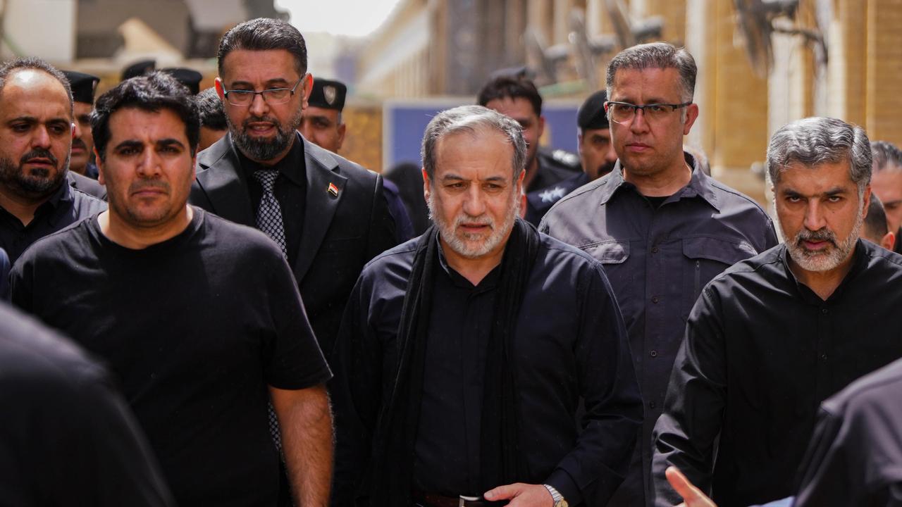 Iran's Foreign Minister Abbas Araghchi, surrounded by security staff