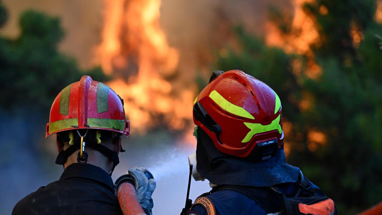 Firefighters operate during a wildfire near Porto