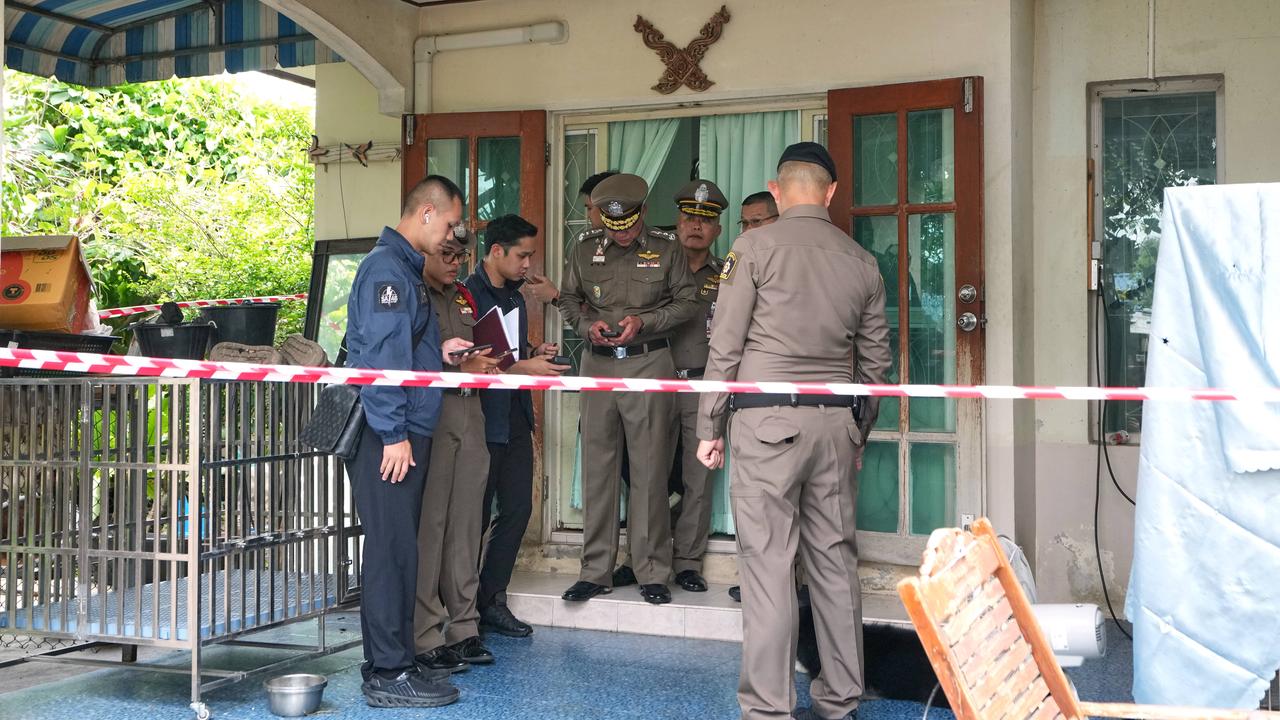 Police outside the home of a student who shot people at a Thai school