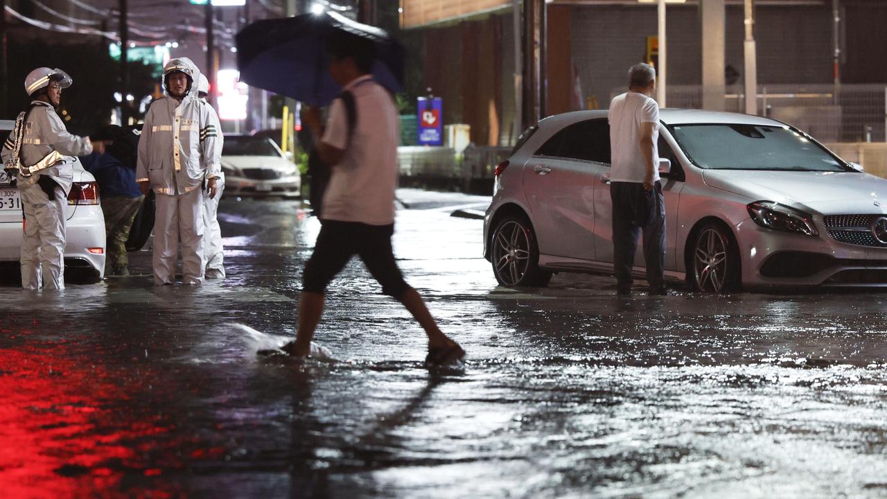 Torrential rain floods a road in Ichikawa, Chiba