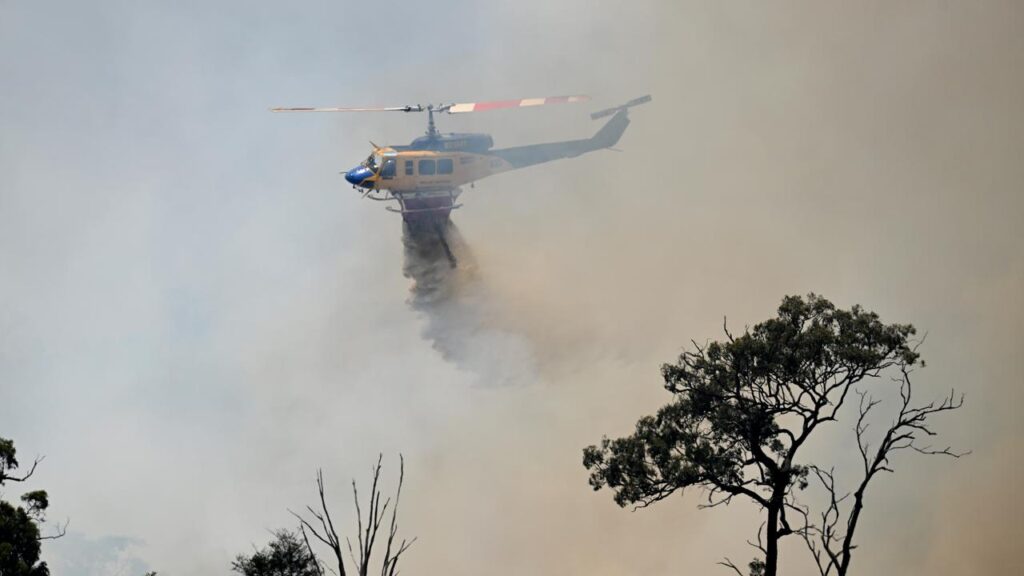Two crew members onboard an Australian-owned firefighting helicopter have died in a mid-air crash.
