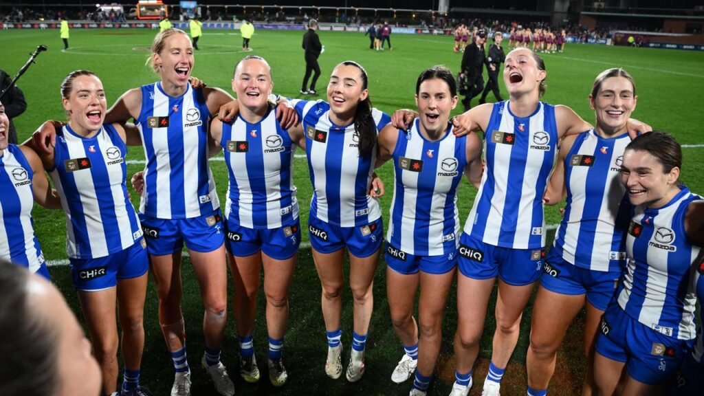 The Kangaroos celebrate their record-extending victory over the Lions in Brisbane. 
