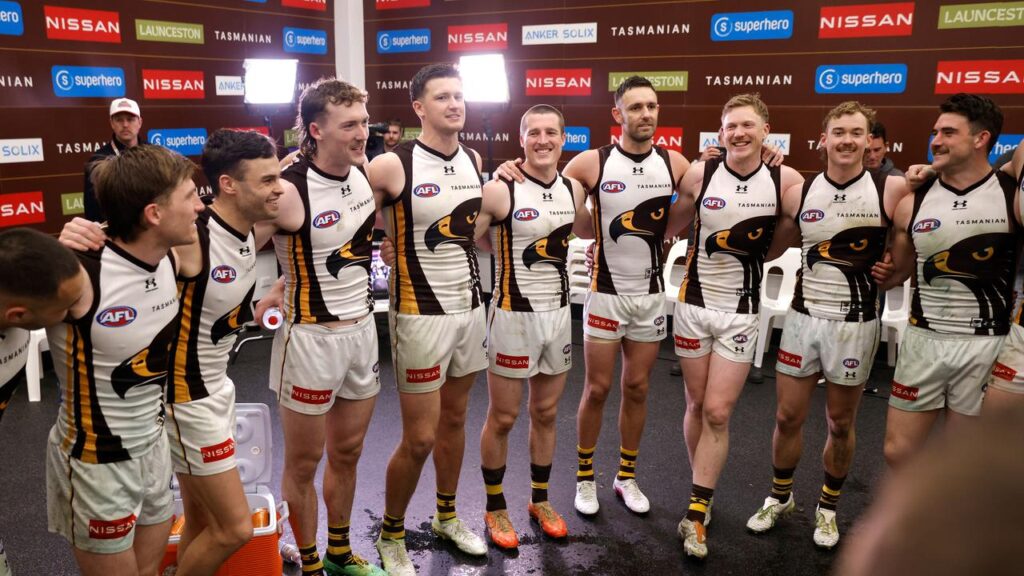 The Hawks sing their team song after beating the Eagles, getting in good voice to face the Dockers.
