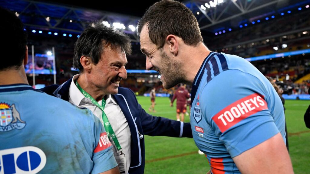 Out on a high: Laurie Daley celebrates the 2026 Origin series triumph with captain Isaah Yeo. 
