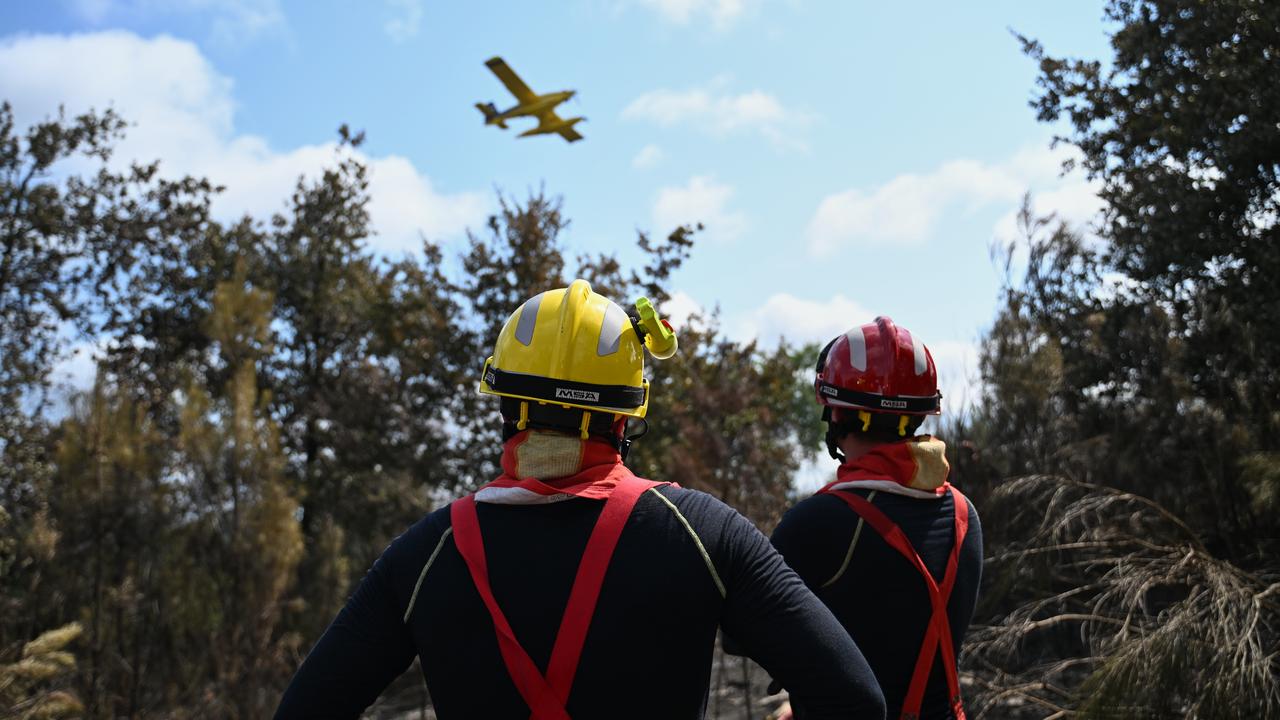 Firefighters and a firefighting aircraft near Lege-Cap-Ferret, France