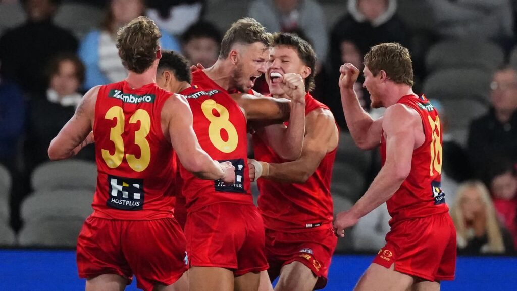 Suns veteran Nick Holman (c) kicked two goals in his final game as Gold Coast defeated St Kilda. 
