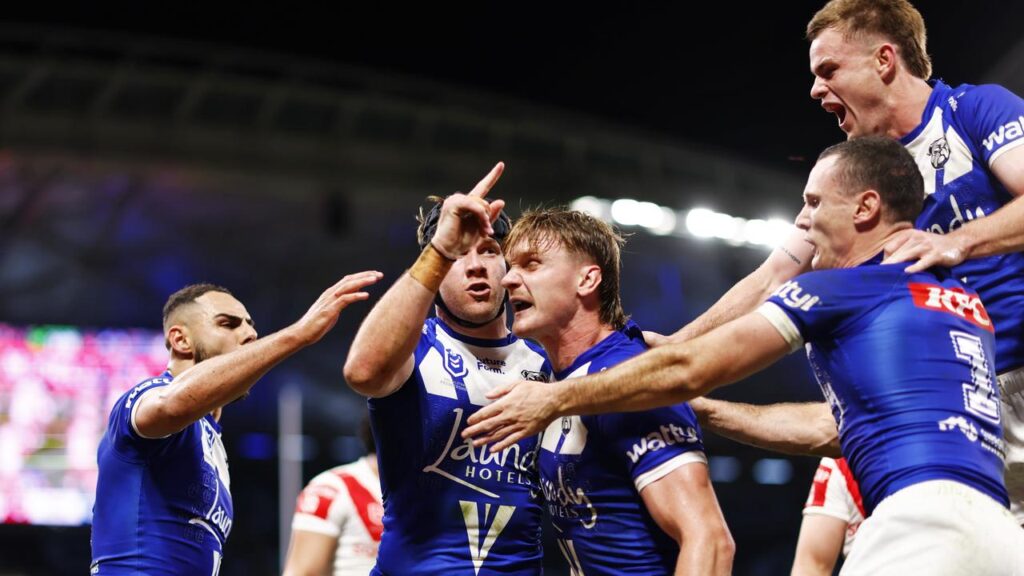Matt Burton’s new right edge partners celebrate one of his two tries against the Dragons.
