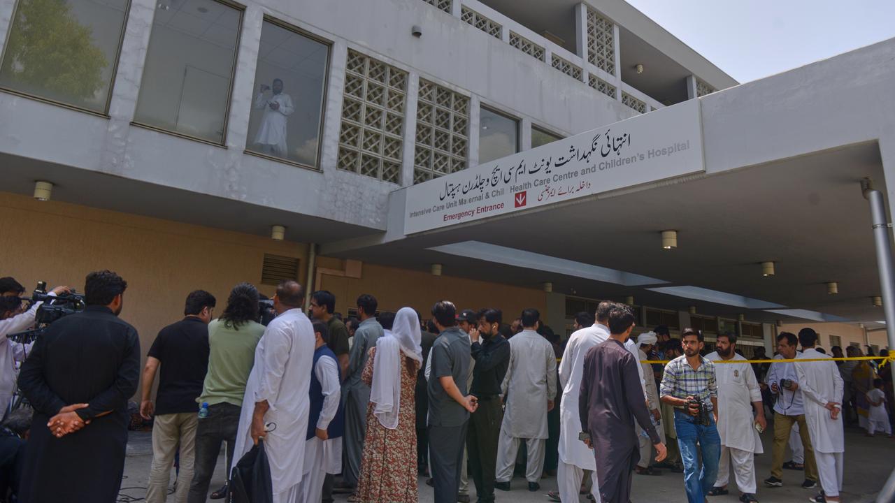 People gather outside a nursery at a hospital in Islamabad, Pakistan