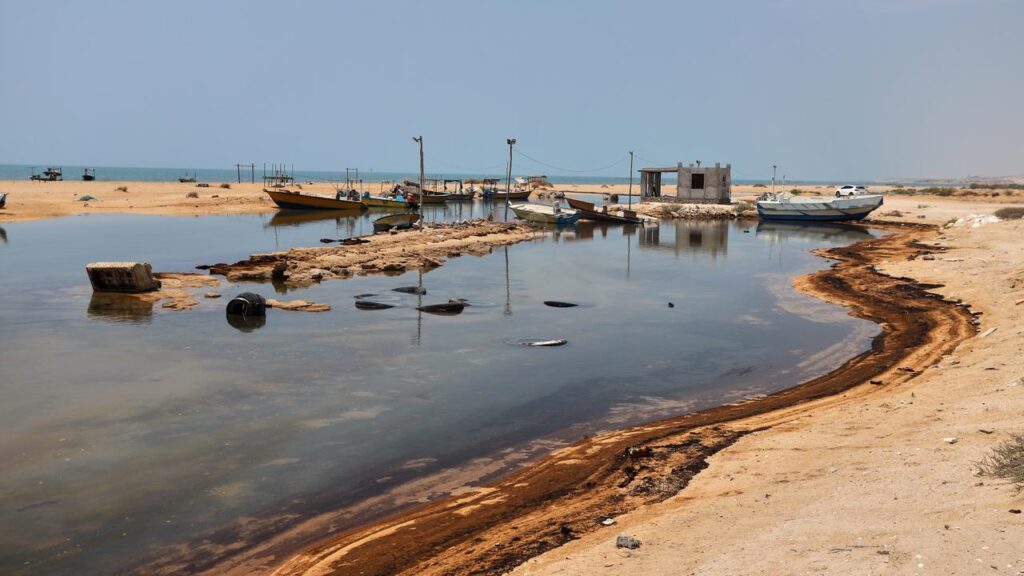 Oil residue lines the shore on Qeshm Island, Iran, amid attacks on vessels in the Strait of Hormuz.
