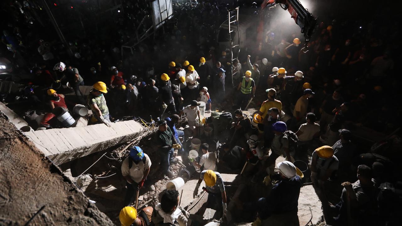 Rescuers search through rubble after an earthquake in Cali, Colombia