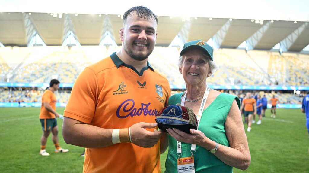 Massimo De Lutiis poses with the granddaughter of the first Wallaby and his original Test cap.
