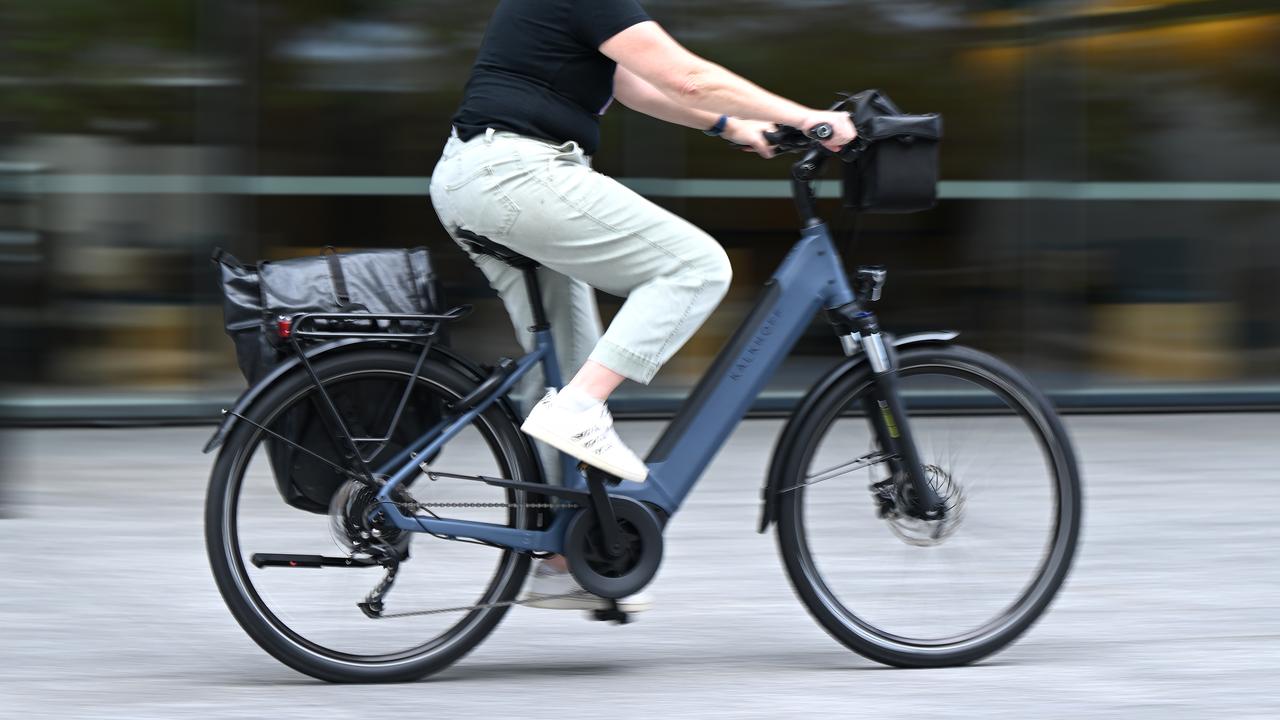 A person riding an e-bike in Brisbane (file image)