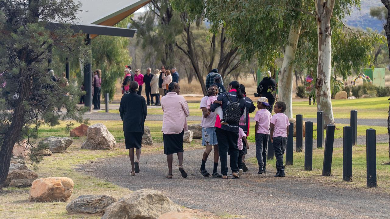 Mourners attend the funeral for five-year-old Kumanjayi Little Baby