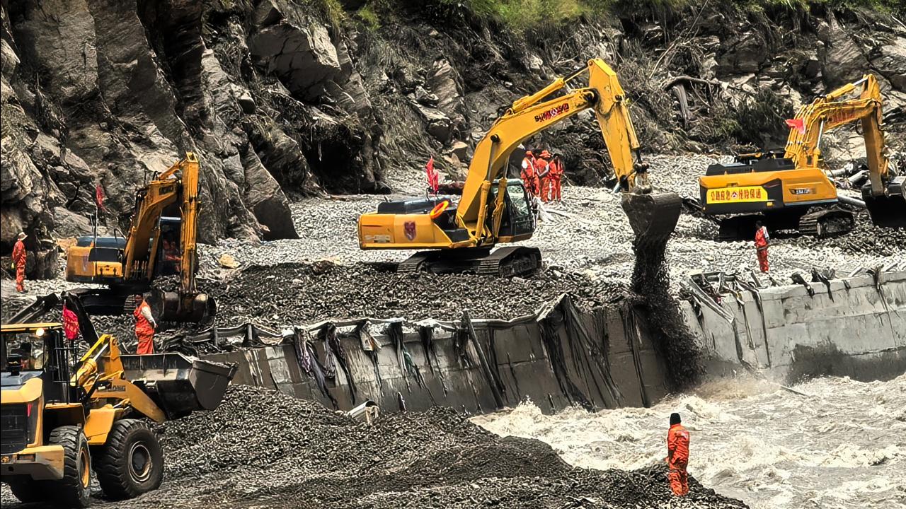 Heavy machines to clear a road to mudslide-hit areas in Xigaze, CHina