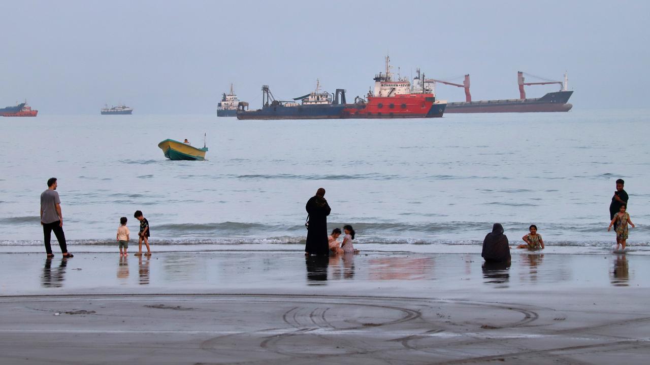 Commercial vessels are anchored in the Strait of Hormuz