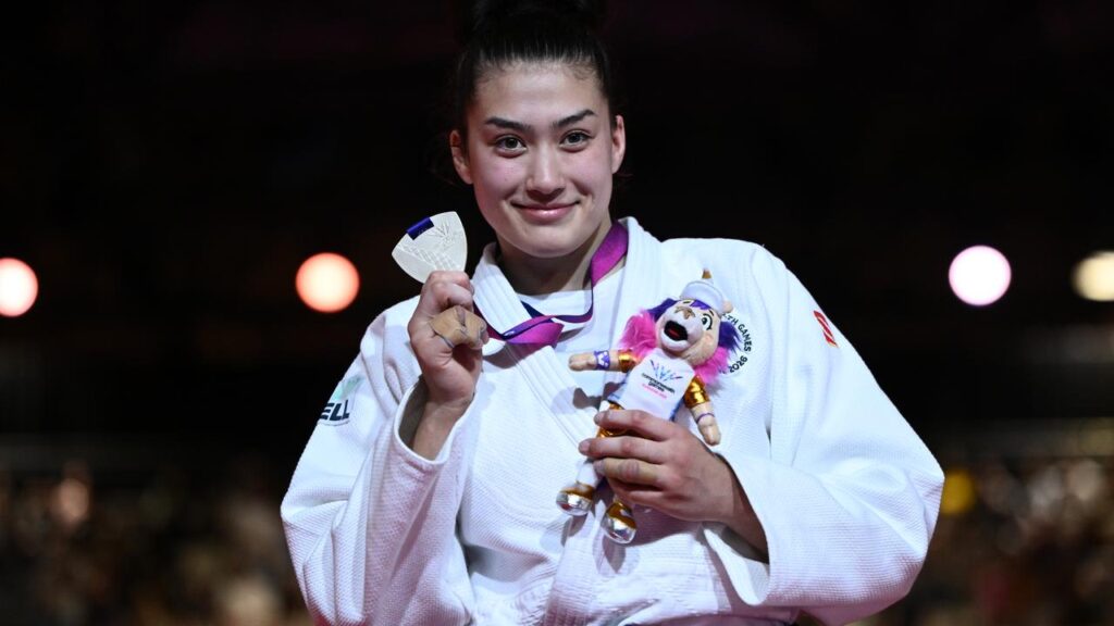 Australia’s Maria Swan shows off her Judo -78kg silver medal at the Commonwealth Games.
