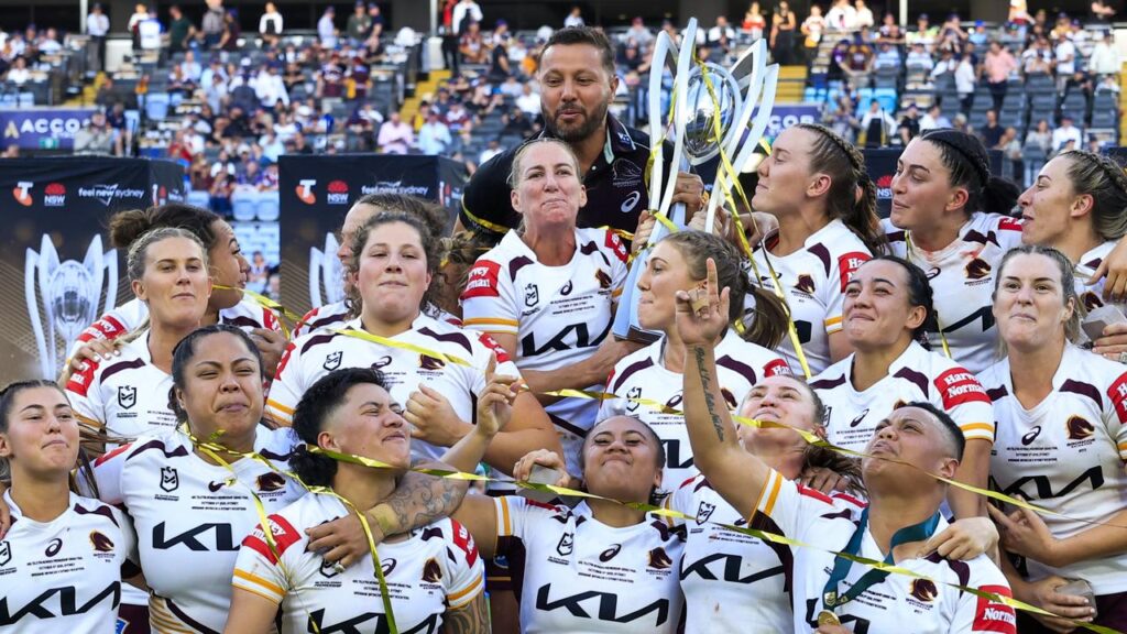 Brisbane players celebrating their 2025 NRLW grand final win over the Sydney Roosters.
