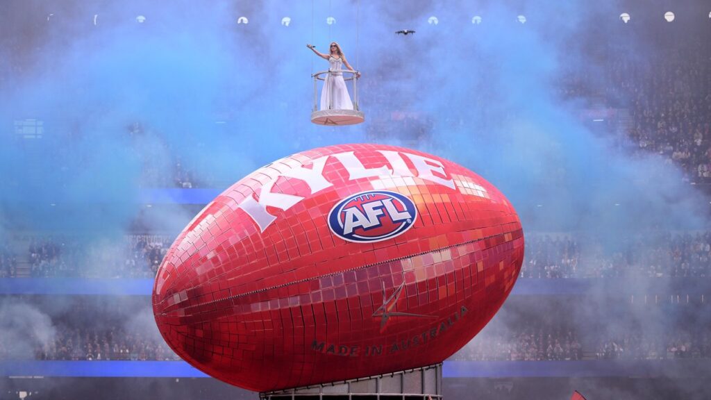 Kylie Minogue has delighted AFL fans at the MCG with a hit-loaded grand final day performance.
