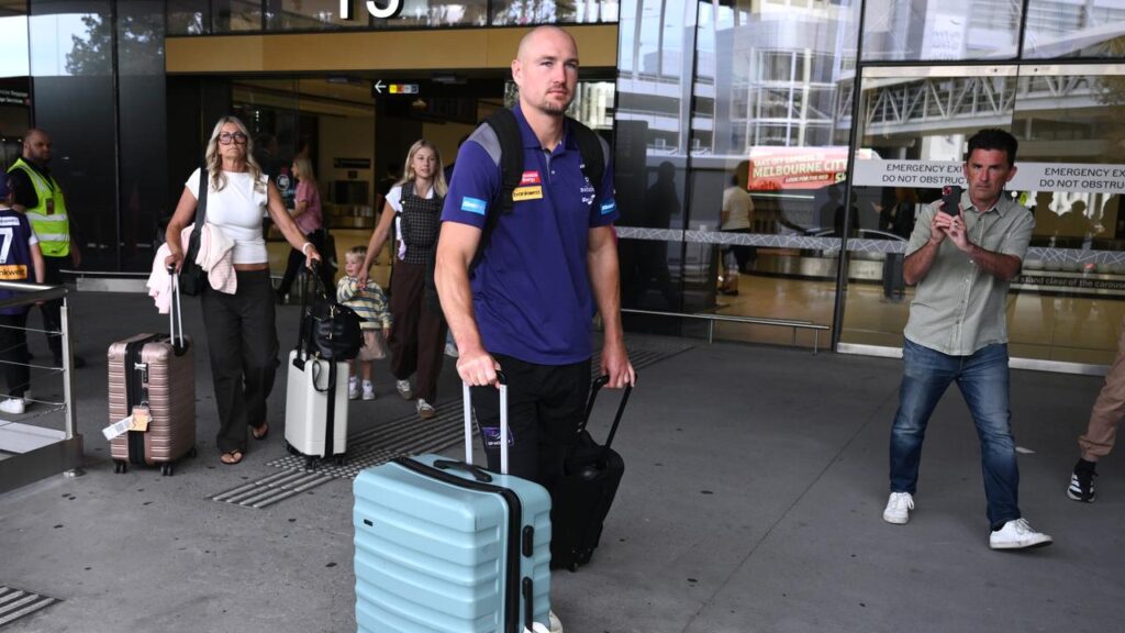 Brennan Cox arrived in Melbourne with Fremantle yet to say whether he’ll play in the grand final.
