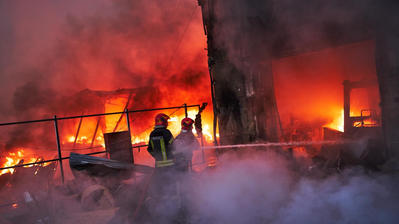 Firefighters try to extinguish a fire after a Russian attack in Kyiv