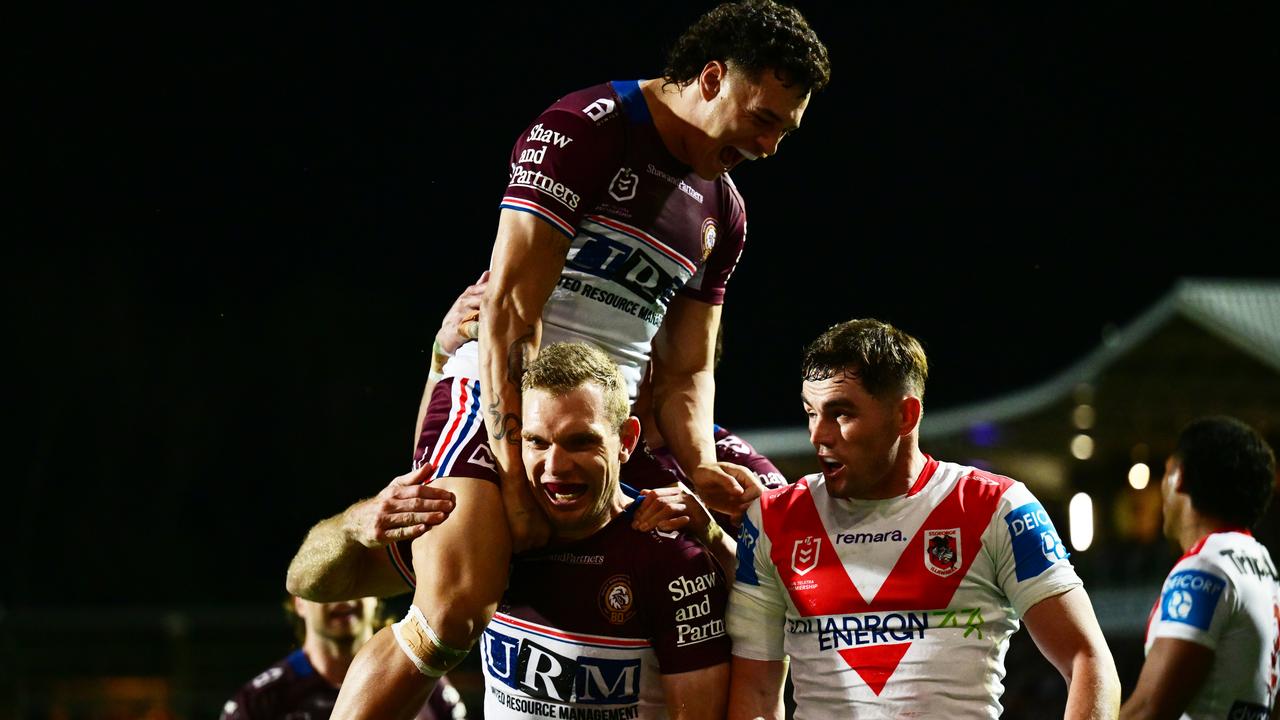 Clayton Faulalo of the Sea Eagles leaps on try scorer Tom Trbojevic